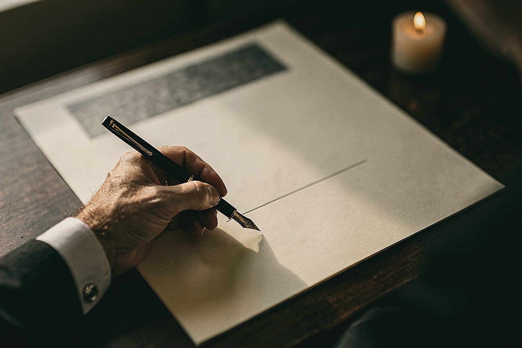 An elder's hand signing a formal trust document with a gold-nib fountain pen on heavy cream paper at a dark wood desk in candlelight.